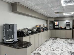 a large kitchen with white cabinets and appliances at SureStay Plus Hotel by Best Western Hopkinsville in Hopkinsville