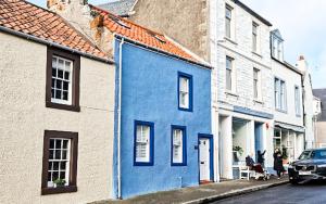 a blue building on the side of a street at Oyster Cottage- relaxing retreat by the sea in Saint Monance