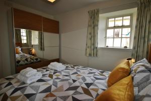 a bedroom with a bed with towels on it at Dolphin Cottage- traditional cottage on Fife Coast in Anstruther