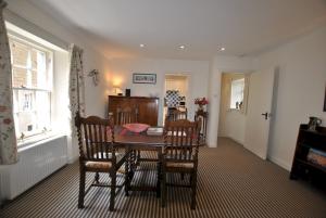 a dining room with a table and chairs and a window at Dolphin Cottage- traditional cottage on Fife Coast in Anstruther