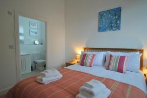 a bedroom with a bed with towels on it at Academy Apartment Anstruther- stunning luxury home in Anstruther