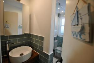 a bathroom with a white sink and a mirror at Willow Cottage- charming cottage in East Neuk in Pittenweem