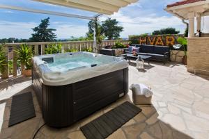 a hot tub sitting on top of a patio at Casa Benita in Hvar