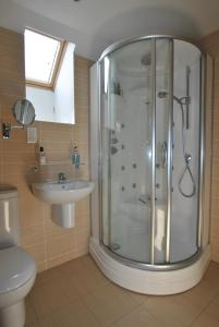 a bathroom with a shower and a sink at Seaview Steading-spacious home in rural location in Crail