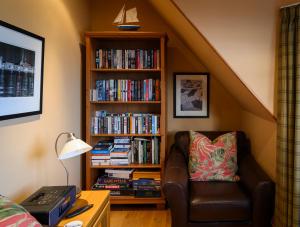 a living room with a book shelf filled with books at Crail Posthouse - 19th Century traditional house in Crail