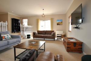 a living room with a couch and a table at Darnley View- spacious countryside retreat in Crail
