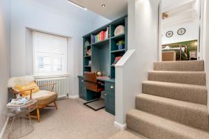 a home office with a staircase and a desk at Honeybee Cottage- stunning home on Fife coast in Anstruther