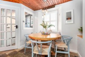 a dining room with a wooden table and chairs at Honeybee Cottage- stunning home on Fife coast in Anstruther