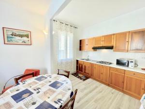 a kitchen with a table and a counter top at Trilocale Jolly in Marina di Bibbona