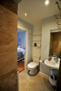 a bathroom with a toilet and a sink and a bed at 2 Melville Terrace Anstruther in Anstruther