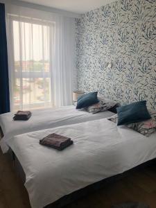 a bedroom with a bed with two towels on it at Apartament Pileckiego Nowy Dwór Mazowiecki Airport Modlin 24 H in Nowy Dwór Mazowiecki