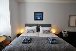 a bedroom with a bed with two pillows on it at Market Apartment- harbourfront studio Pittenweem in Pittenweem