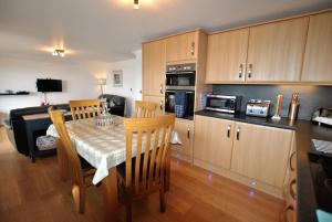 a kitchen with a table and chairs and a kitchen with a table and a kitchen at Kittle View near Anstruther in Carnbee