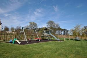 a playground with a slide in the grass at Kittle View near Anstruther in Carnbee