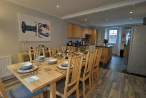 a kitchen and dining room with a wooden table and chairs at Misty Morn- stunning home in East Neuk in Anstruther