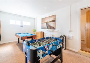 a room with a foos ball and a table at Coastal Haven- stunning home in Crail in Crail