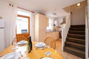 a kitchen and dining room with a table and chairs at Sea Whisper- lovely home in charming village in Pittenweem