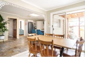 a dining room with a wooden table and chairs at Home in Frankston in Frankston