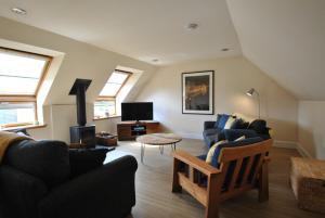 a living room with two couches and a tv at Seaglass Cottage-family friendly home in East Neuk in Pittenweem