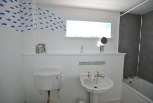 a bathroom with a toilet and a sink at Seaglass Cottage-family friendly home in East Neuk in Pittenweem +22 photos