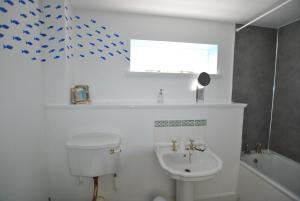 a bathroom with a toilet and a sink at Seaglass Cottage-family friendly home in East Neuk in Pittenweem