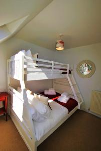 a bedroom with two bunk beds in a room at Seaglass Cottage-family friendly home in East Neuk in Pittenweem