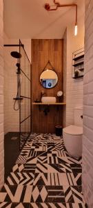 a bathroom with a tub and a toilet in a room at Puerto Principe LOFT in Santander