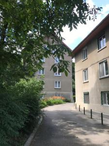 a building with a road in front of it at La Rossa in Braşov