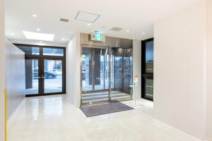 an entrance to a building with a revolving door at Hotel Sanrriott Osaka Hommachi in Osaka