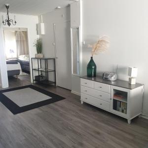 a living room with a dresser and a mirror at Rauhallinen kaksio keskustassa in Imatra