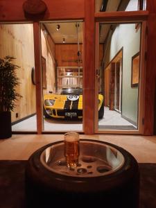 a car in a garage with a tire in a room at Lærdalsøren Motor Guesthouse in Lærdalsøyri