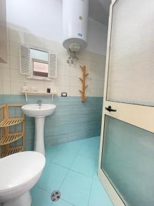 a bathroom with a sink and a toilet at Mediterranean Sea Apartments in Durrës