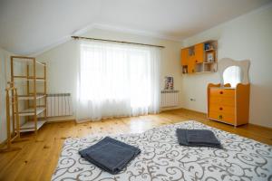 a bedroom with a bed with two towels on it at Villa & SPA Owerko in Chyshky