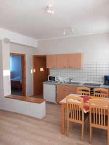 a kitchen and dining room with a table and chairs at Ferienhof Rüßmann in Lennestadt