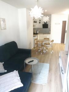 a living room with a couch and a table at EASY RENT Apartments- Kazimierz Dolny Doły 4 lok 4 in Kazimierz Dolny