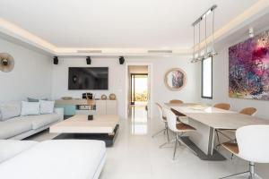 a white living room with a couch and a table at Puente Romano Luxury Villa in Marbella