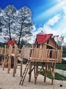 a group of wooden play structures on a playground at Appartements Zur Auszeit in Waldkirchen +9 photos