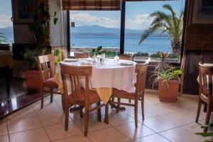 a table in a restaurant with a view of the ocean at Hotel Lefkadi in Lefkandi Chalkidas