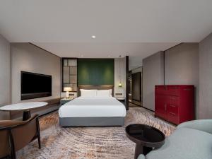 Voodi või voodid majutusasutuse Shenzhen Shanghai Hotel toas