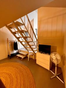 a bedroom with a staircase and a bed with a television at Apartments Zore Dubrovnik in Dubrovnik