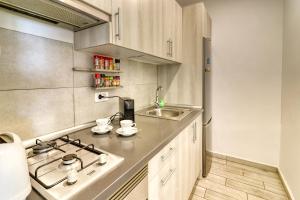 a kitchen with a sink and a stove at Modern apartment with an addictive terrace view in Los Cristianos