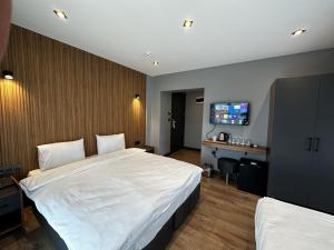 a hotel room with two beds and a desk at Bademi Room in Edirne