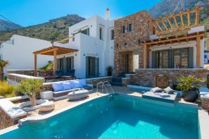 a villa with a swimming pool and a house at VILLA DIMAR SIFNOS in Kamares