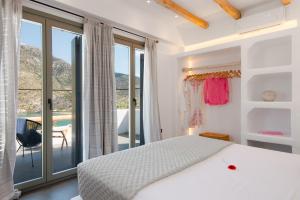 1 dormitorio con 1 cama y balcón en VILLA DIMAR SIFNOS, en Kamarai