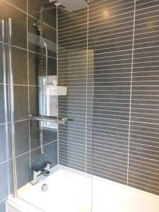a bathroom with a shower with a sink at Beautiful 3 bedroom home with large garden 35 mins to Glasgow & Edinburgh in Whitburn