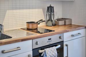 a kitchen with a stove with a pot on it at For Students Only Exquisite Modern Studios at Upperton Road in Leicester in Leicester