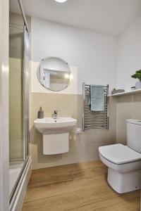 a bathroom with a sink and a toilet and a mirror at For Students Only Exquisite Modern Studios at Upperton Road in Leicester in Leicester