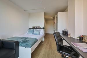 a bedroom with a bed and a desk with a chair at For Students Only Exquisite Modern Studios at Upperton Road in Leicester in Leicester