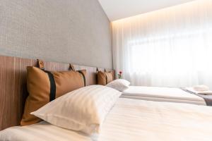 a bedroom with two beds and a window at Pan Tadeusz in Vilnius