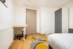 a white bedroom with a desk and a bed at Birmingham City Centre Apartment room near China Town in Birmingham